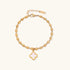 18K gold-plated oval bead bracelet with a four-leaf clover charm in mother-of-pearl or black enamel, adjustable lobster clasp, on white background.