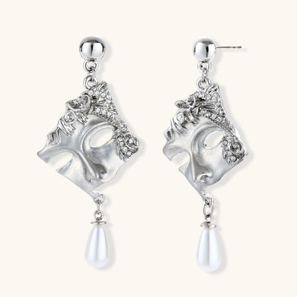 Ornate silver-toned masquerade mask jewelry set featuring rhinestone details and pearl drop earrings on white background.